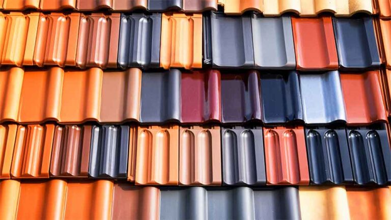 Various colored clay and metal roofing tiles displayed in rows.