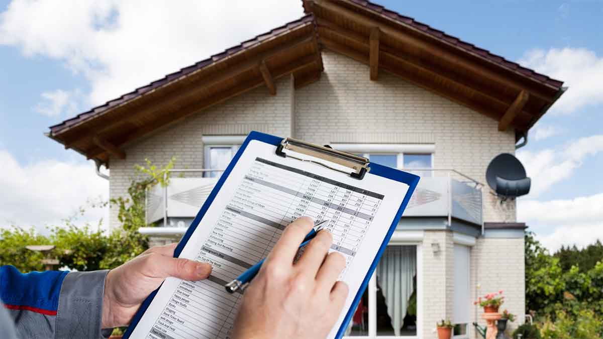 Inspector reviewing a roof checklist in front of a house.