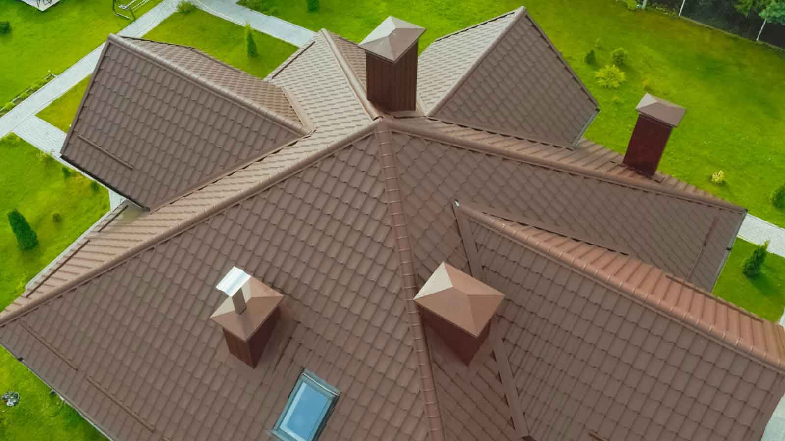 Aerial view of a house with a brown metal tile roof.