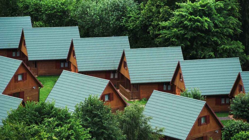 A cluster of houses with green metal roofs.