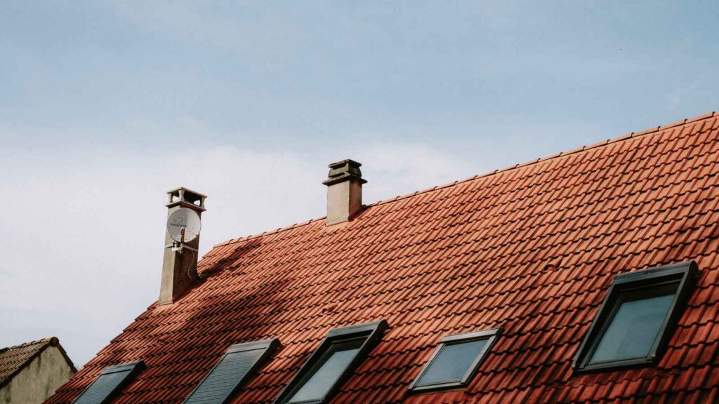  A roof with red French Provincial clay tiles and skylights.